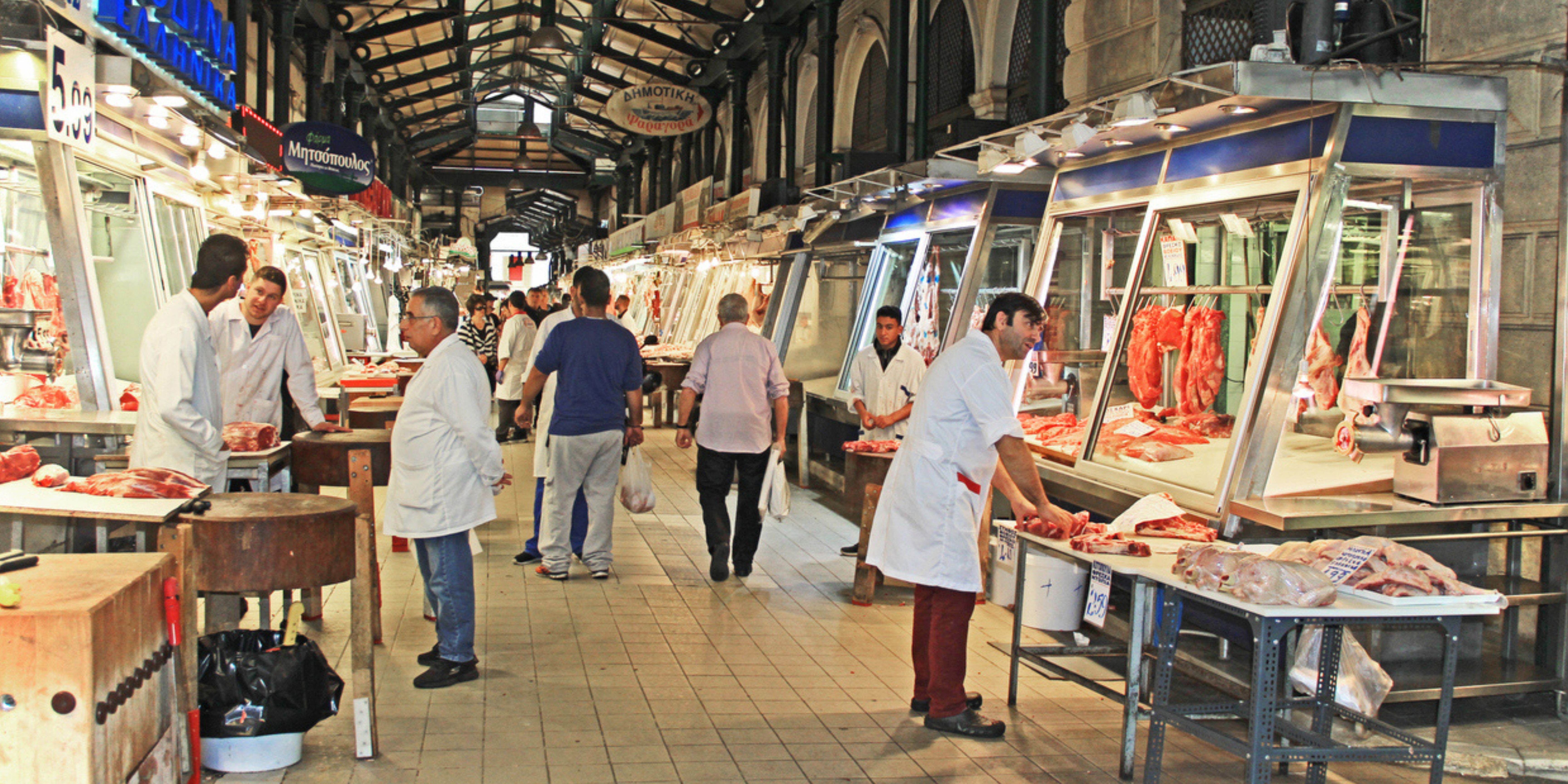 Butchers and customers at the meat section of Varvakios Market in Athens.
